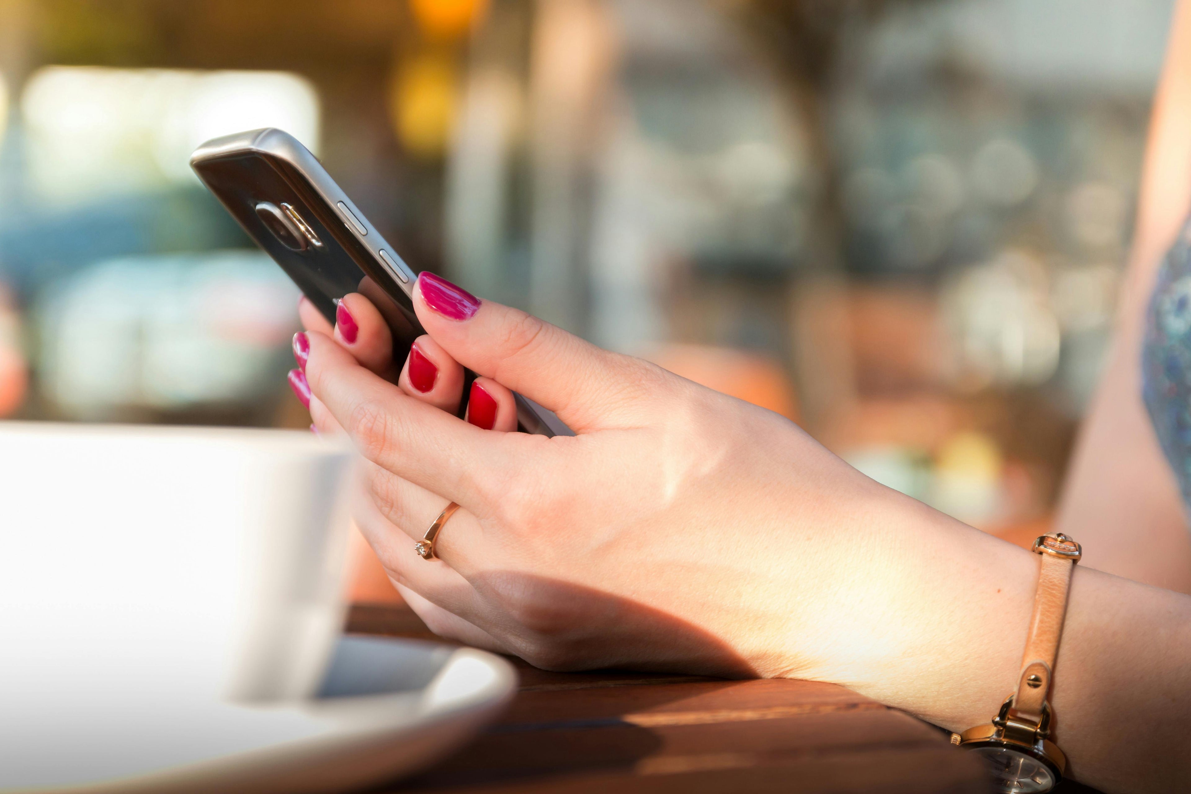 lady holding smartphone by jeshoots at pexels